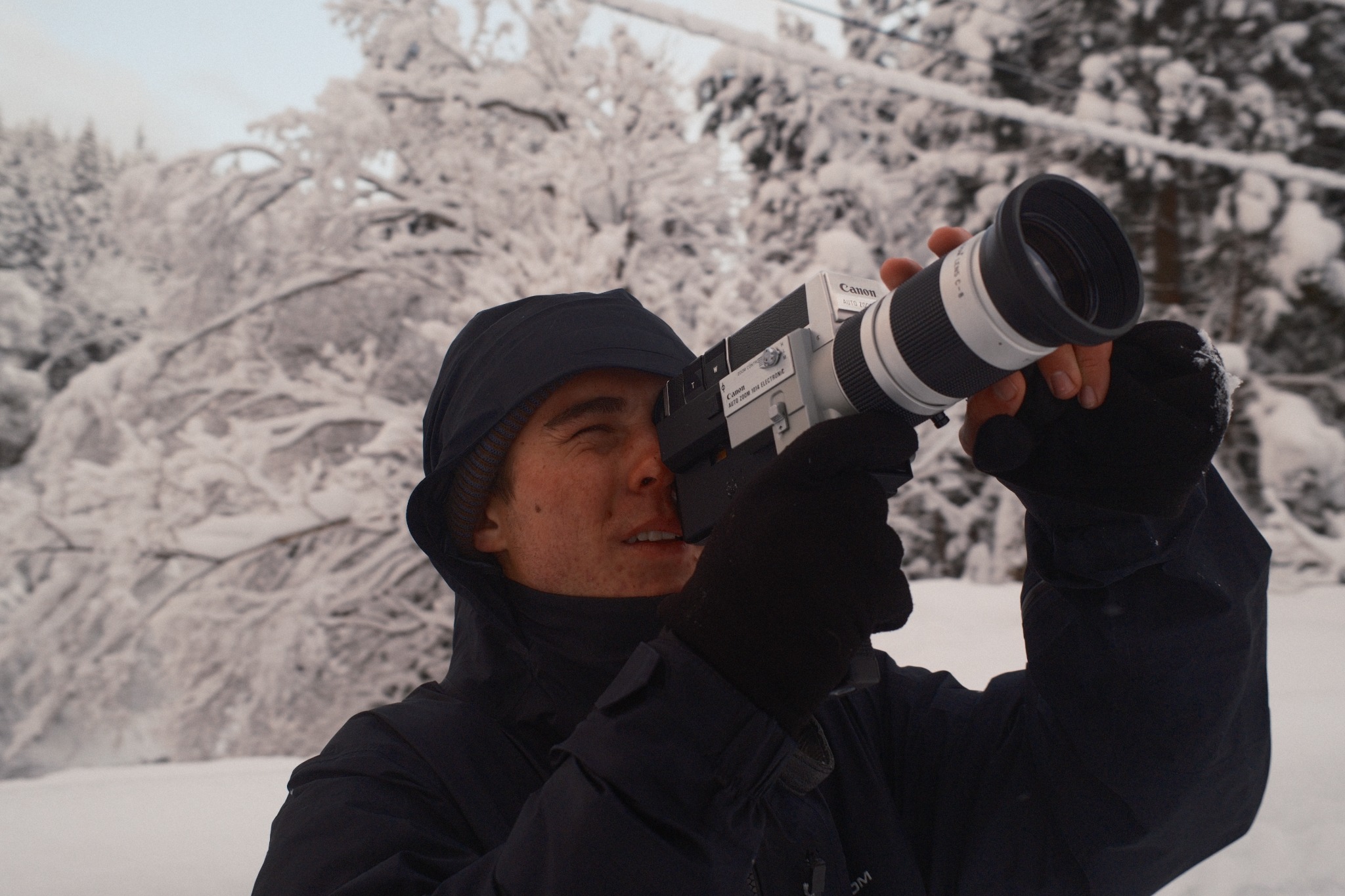 Filmmaker using a camera in the snow